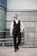 © Galka3250 - Stylish Businessman in Modern Attire Posing Confidently Outdoors