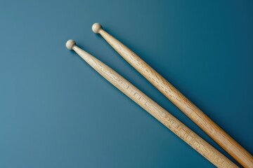 Drumsticks resting on a blue background