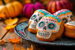 © iamfrk7 - Decorated sugar skull cookies on a wooden plate, surrounded by fall leaves and pumpkins, perfect for Day of the Dead or Halloween celebrations.