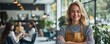 © Georgii - Confident female salon owner standing proudly in her modern salon, wearing an apron and smiling warmly at the camera