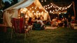 © Ilja - Friends Gathering Around Bonfire, Enjoying Summer Evening Party with Tent and String Lights