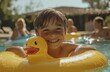 © Georgii - A young boy joyfully smiling while holding a yellow inflatable duck in a swimming pool on a sunny day