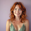 © Robert Kneschke - Portrait of a ginger-haired woman in her 40s with a radiant smile and natural beauty against a lavender background