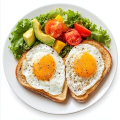 Healthy breakfast. Two fried eggs with vegetables, toasts,and avocado on white plate. Top view.