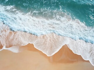 Aerial view of ocean waves meeting sandy beach.