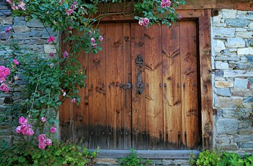 Wooden gate in the wall of the house