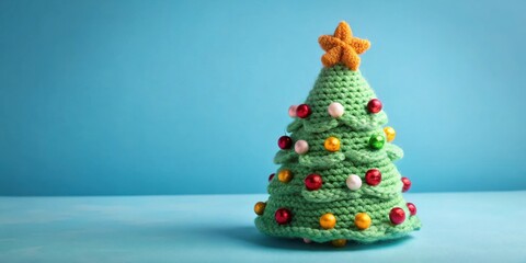 Handmade crochet Christmas tree knitted on light blue background for festive holiday decor