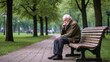 © Natalia Barsukova - Old thoughtful man sitting on the bench in the green park