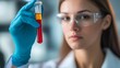 © Vladyslav Tykhonov - Close-up of a lab technician holding a test tube containing a precision sample, representing advanced biotechnology research