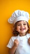 © Todd's Studio - a cute child wearing a chef's hat smiling with a bright colored background, editorial photography, white shade background, happy