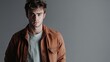 © Khalil - Handsome young man in casual wear looking at camera while standing against grey background