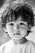 © wolfhound911 - Black and white portrait of a preschooler Japanese boy with messy hair, clear skin, and curious eyes, lit by natural daylight.