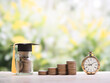 © maybeiii - Glass bottle with graduation hat, Vintage watch and stack of coins. The concept of saving money and manage time for education, student loan, scholarship, tuition fees