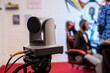 © InveStock - A PTZ camera or camcorder records a podcast show in a studio with state-of-the-art broadcasting equipment. professional microphones, headphones and lighting, creating a high-tech media production