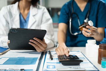 doctor or accounting department writes a note and uses a calculator to calculate expenses - income. 