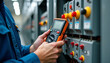 © LuisAlfonso - Electrical testing industrial electrical circuits using a multimeter in the control terminal box is part of the electricity and electrical maintenance service.