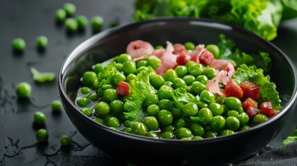 Wall Mural - A vibrant green pea salad served in a black bowl, garnished with crispy bacon bits, creating a delightful and colorful culinary display.