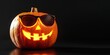 © Corri Seizinger - Happy Halloween celebration party holiday concept greeting card - Cool funny carved pumpkin with sunglasses, isolated on dark black table background