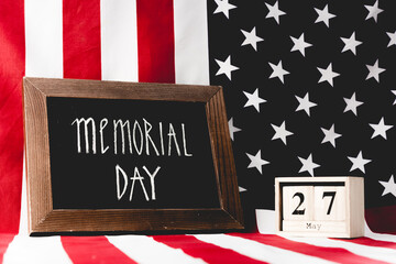 Sticker - A beautifully arranged display honors Memorial Day with flags and a date reminder, capturing the essence of respect.