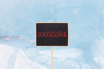 Successful symbol. Concept word Successful on beautiful chalk blackboard. Beautiful blue ice. Beautiful blue ice background. Business successful concept. Copy space.