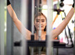 © tai - fitness asian woman pulling workout station. beautiful athletic girl pulling heavy system bar using strength. attractive female exerciser workout weight training pulling bar to support body strength