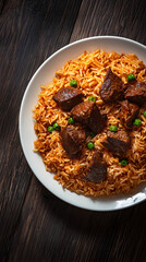 White plate is presenting a delicious indian biryani with beef and green peas on a wooden table