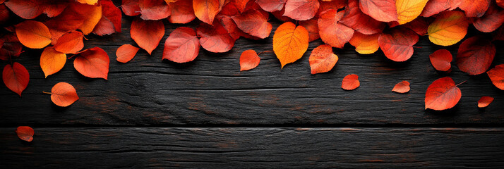 Poster - Red and orange leaves scattered on a dark wood background.