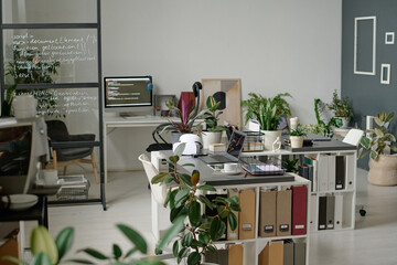 Wall Mural - Fully equipped modern office with several workspaces and huge number of verdant plants