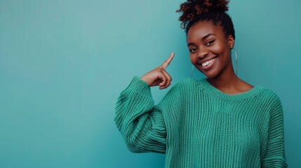 Wall Mural - A woman in a green sweater is pointing to the sky