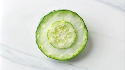 Wall Mural - A single, fresh cucumber slice on a marble background.