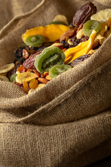 Poster - Dried tropical fruits and nuts in burlap bag.