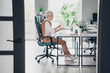 © deagreez - Full size photo of smart elderly chief lady analyze graph sit table wear formalwear comfortable office loft room interior indoors workspace