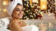 © Anna - A woman with a towel wrapped around her hair smiles warmly while leaning against plush towels in a cozy spa setting, adorned with festive holiday lights and a serene ambiance