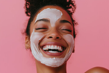 Wall Mural - Cropped image of cheerful smiling young African American diverse young woman with applied deep cleansing nourishing facial face mask, pink background with empty copy space.