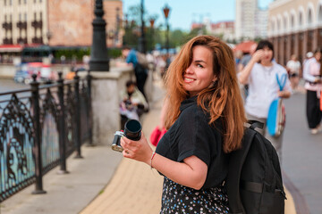 A young woman travels around Europe, walks the streets in the summer. Kaliningrad, Fishing village.