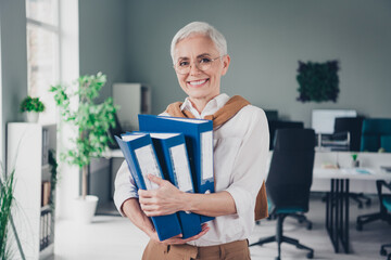 Canvas Print - Photo of smart elderly chief female hold paper folders wear formalwear comfortable modern office loft room interior indoors workspace