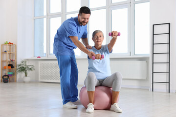 Sticker - Senior patient exercising under physiotherapist supervision in rehabilitation center