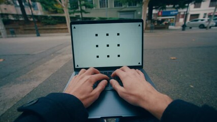 Man outdoor opens laptop computer and start typing on keyboard, POV chromakey 