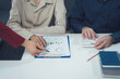 © Kritdanai - Business Collaboration: Strategic Planning: A team of professionals collaborate on a business strategy, analyzing data and charts in a focused, collaborative environment.
