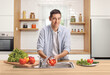 © Ljupco Smokovski - Young man washing tomato in a kitchen sink