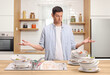 © Ljupco Smokovski - Angry man with a pile of dirty dishes in a sink
