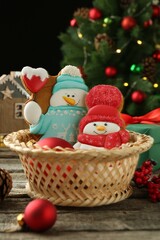 Wall Mural - Delicious cookies in shape of snowmen and Christmas decor on wooden table