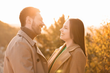 Wall Mural - Beautiful couple spending time together in autumn park