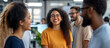 © AI_images - A diverse group of professionals in a brightly lit office, discussing a decision with cheerful expressions. Their animated gestures and laughter contrast with the blurred, minimalist background,
