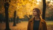 © Horizen - Woman enjoying a leisurely walk in an autumn park amidst golden foliage