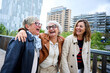 © CarlosBarquero - Three cheerful only mature Caucasian friends women enjoying walking happy together in urban park. Older gray hair tourists female people strolling laughing European sightseeing holidays outdoors