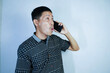 © syahril - an excited Asian man called his business partner