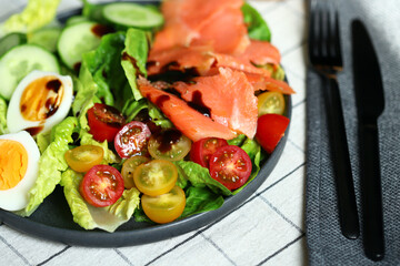 Fresh salad with cucumber, cherry tomatoes and salted salmon