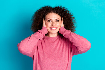 Poster - Photo of nice young woman beaming smile arms covert ears wear pink pullover isolated on teal color background