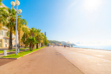 The wide pedestrian Promenade des Anglais seaside walkway along the Mediterranean Sea Bay of Angels at Nice, France, French Riviera Cote d'Azur.